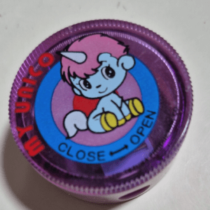 Purple bottle cap with a blue baby unicorn and pink mane inside a blue ring; shows 'CLOSE' and 'OPEN' with arrows for turning direction.