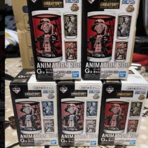Four Bandai Animation 20th collectible figure boxes stacked on a surface, each with bold character artwork in red tones on the front. A cardboard box is in the background.