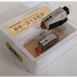 Phono cartridge and diamond stylus in a white plastic case with a yellow label reading Nagaoka 86-31EP (TECHNICA).