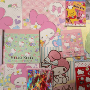 Colorful wall collage of Hello Kitty and My Melody merchandise—notebooks, cards, and posters with pastel pinks and floral patterns.