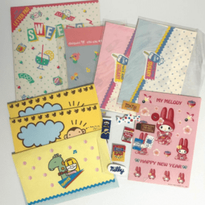 Assorted cute stationery set including letter pads, envelopes, and notepads with cartoon characters and pastel designs.
