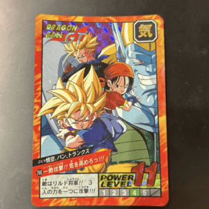 Dragon Ball GT trading card with a red-orange border, showing Goku (kid), Trunks, and others in action poses; the Dragon Ball GT logo is in the top left corner and a power level bar appears at the bottom right.
