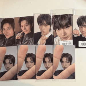 Rows of glossy photo cards featuring a young man in different poses, some with a finger to the lips gesture, arranged in two rows on a surface