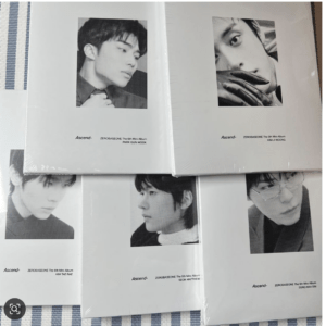 Black-and-white collage of six portrait photos arranged in a grid, each page showing a close-up headshot of a young man with small caption text beneath (album-related credits).