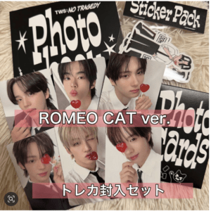 ROMEO CAT ver. trading card set with photo cards of multiple members, each holding heart-shaped lollipops, plus a sticker pack in the background.