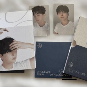 K-pop photo cards and album booklets, featuring a man in a white T-shirt on several portrait cards with blue and navy album covers around them.