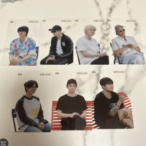 Seven BTS photocard cards from In The SOOP 2, each featuring a different member in casual outfits, arranged on a light surface.