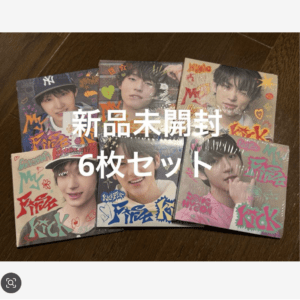 Six unopened photo albums (idol group) arranged on a wooden surface; cover art with colorful text, overlay says 新品未開封 6枚セット.