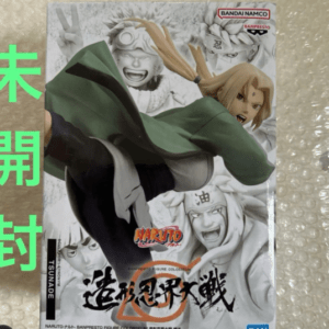 Naruto action figure box starring Naruto Uzumaki in a green cloak striking a dynamic pose; grayscale background with other characters and Bandai Namco logos, plus bold green vertical Japanese text on the left.