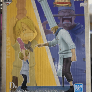 Box for One Piece figure set 'Dr Revive Moment' featuring Sanji and Zeff, Bandai Namco, with yellow and blue packaging in the background.