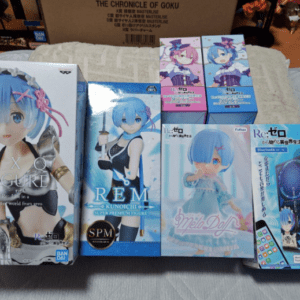 Several anime figure boxes are arranged on a couch, prominently featuring blue-haired Rem figures from Re:Zero (EXQ/Rem, SPM, and others).  Articulos Japan (Post Box Japan)
