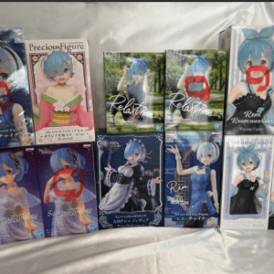 Collection of blue-haired anime figure boxes arranged on a white cloth, with several faces redacted by red scribbles.  Articulos Japan (Post Box Japan)
