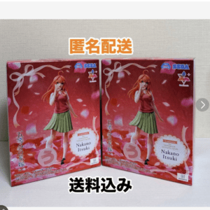 Two boxed Nakano Itsuki anime figures in red tops and green skirts, standing side by side on a pink background.