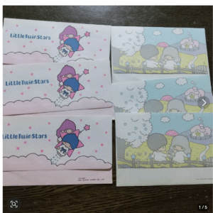 Little Twin Stars stationery set with pastel pink clouds and two star-child characters in envelopes/notepads.