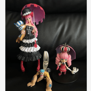 Three anime-style figurines arranged on a black leather couch: a tall woman in a black-and-white tiered dress holding a pink parasol, a pink-haired girl with a crown on a small stand, and a crouching figure with a long, knife-like head and blue accents.