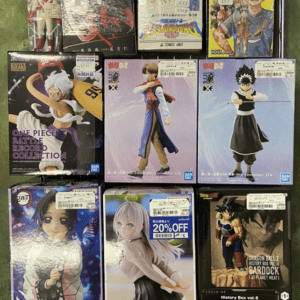 Shelf of anime figure boxes showing One Piece, My Hero Academia, and Dragon Ball characters ready for sale/collection.
