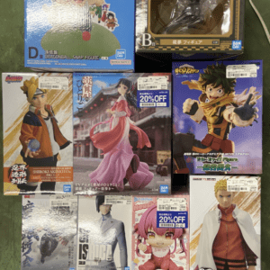Assorted boxed anime figures on a green display rack, featuring characters from popular series like Dragon Ball and One Piece.