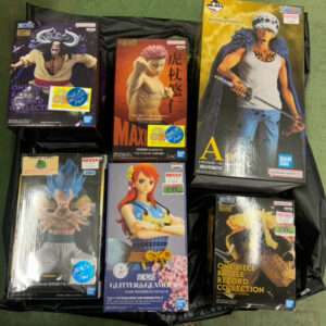 Six boxed anime figures arranged on a black surface, including One Piece Battle Record Collection boxes among other character figurines on display.