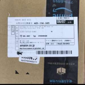 Cardboard box with a white shipping label showing Amazon.co.jp and a barcode.