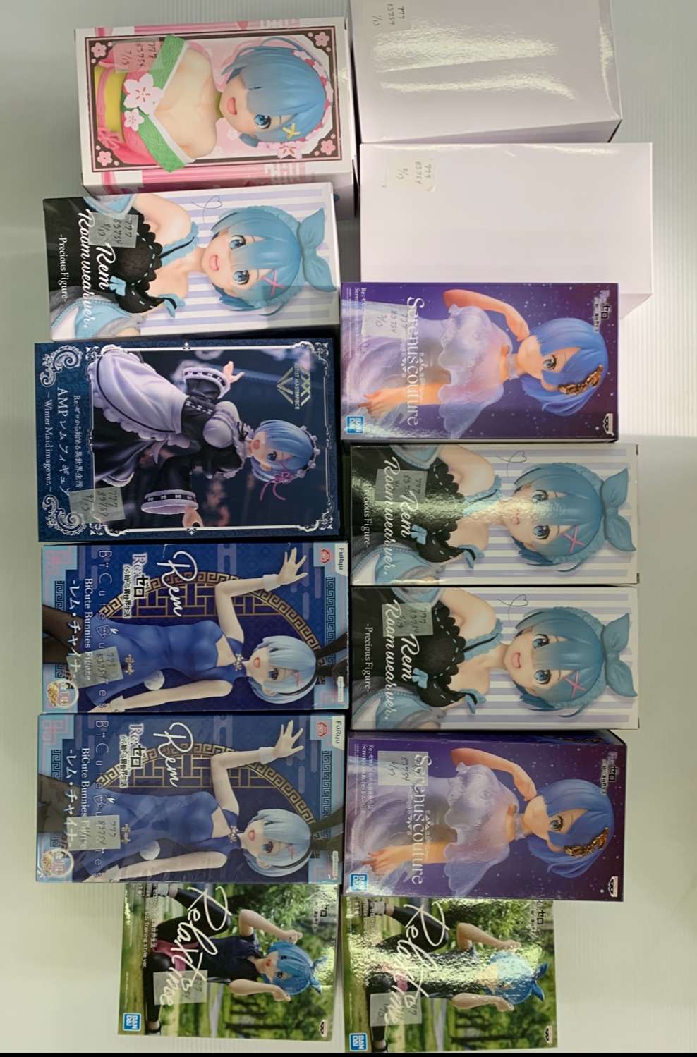 Img_2039 - Articulos Japan (post Box Japan) Collection of boxed anime figures featuring a blue-haired character in different outfits stacked on a surface, showing varied packaging art. Articulos Japan (Post Box Japan)