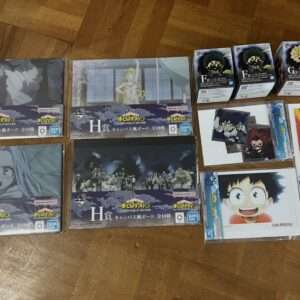 My Hero Academia merchandise spread on a wooden floor: multiple H prize boxes, smaller character boxes, and a poster/kit on the right side.