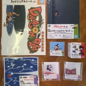 Dragon Ball EX merchandise laid out on a wooden floor, including a large poster, a G collection set, and several boxed items.