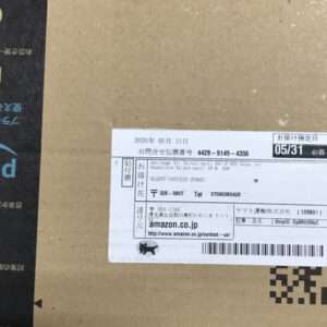 Cardboard shipping box with a white shipping label showing recipient and tracking details, including a barcode and Japanese text.