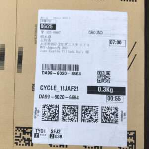 Cardboard box with a white shipping label showing GROUND, tracking DA99-6020-6664, weight 0.3 kg, and several QR codes.