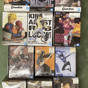 Display of boxed anime action figures (Grandista) arranged on a metal rack, fronts visible with colorful character artwork on each box.