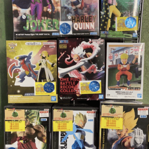 Assortment of boxed collectible figure boxes displayed on a rack, including Batman characters like Joker and Harley Quinn.