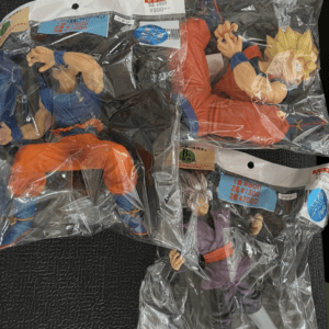 Dragon Ball Z action figures sealed in clear bags, showing Goku in orange gi and two other characters.