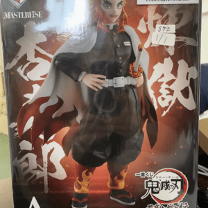 Boxed Demon Slayer: Kimetsu no Yaiba Masterlise figure of a character in a black uniform with a white cape, flaming boots, and a sheathed sword.