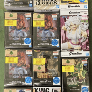 Shelf of boxed anime figures from Dragon Ball, One Piece Glitter & Glamours, and Grandista lines on display