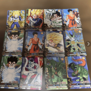 Sixteen Dragon Ball trading cards laid out in four rows on a wooden surface, featuring characters like Goku, Vegeta, Frieza, and Cell in action poses.