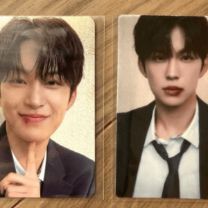 Pair of ID photos: a young man in a suit; left image smiling with a finger near the chin, right image with a neutral expression in a suit and tie.