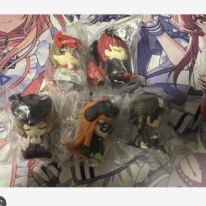 Five mini chibi anime plush figures in clear bags laid on a colorful illustrated backdrop.
