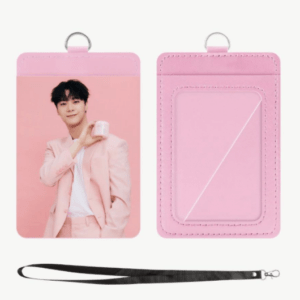 Pink cardholder with a clear back ID window and metal loop; front shows a man in a pink suit holding a mug, with a black lanyard below.