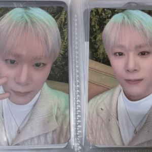 Two side-by-side selfies of a person with pastel blue-green hair, wearing a cream cardigan, inside a clear photo album.