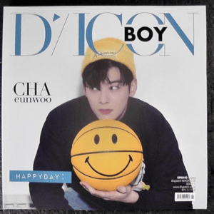 Cover of a fashion magazine showing a young man in a yellow hat holding a yellow smiley-face ball, with 'HAPPYDAY' and 'CHA eunwoo' text visible.