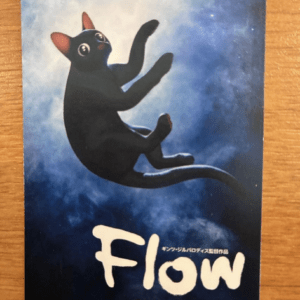 Flow movie poster: a black cat mid-leap against a blue space background, with the white 'Flow' title and yellow '3.14 (FRI)' release date.