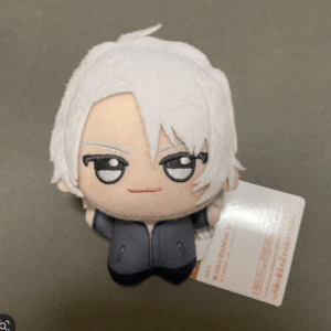 Small plush toy of a white-haired anime character wearing a dark jacket, with a tag attached on the side.