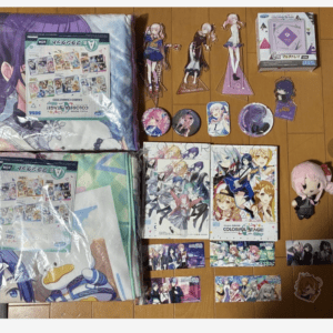 Collection of anime merchandise spread on a wooden floor: plush cushions, standees, posters, cards, and a pink plush doll with colorful character art.