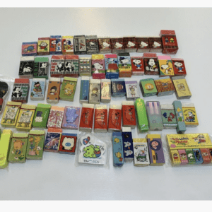 Colorful collection of small boxed erasers with cartoon characters arranged in rows on a white surface.