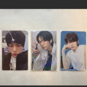 Three photo cards of a young man in different poses laid on a light surface: left with a headband, middle with a peace sign and holographic pattern, right in a white sleeveless shirt against a blue background.