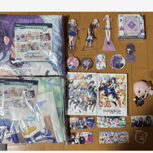 Collection of anime merch on a wooden floor: two folded blankets, character standees, pins, posters, and a pink plush doll.