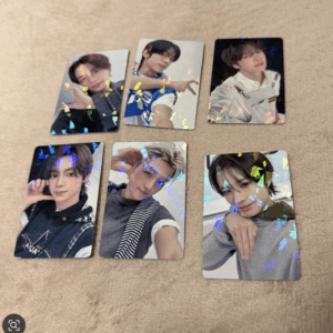 Six glossy photo cards of a young man posing in different outfits, arranged on a beige carpet with colorful confetti overlays.