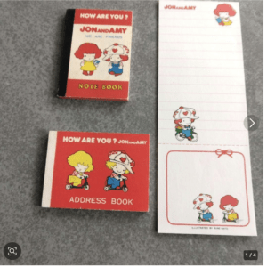 Vintage Jon & Amy stationery: red address book and small note book with cartoon kids, plus a tall lined notepad with illustrations on the right.