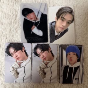 Six photo cards arranged on a light rug show a young man in different outfits, including a hoodie, blazer, and beanie.