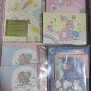 Boxed set of pastel Sanrio stationery featuring Hello Kitty, My Melody, and friends in pink, blue, and yellow designs on multiple notebooks and cards.