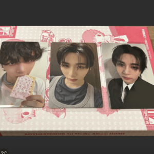 Three portrait photos of a young man with dark hair arranged on a pink patterned box.